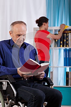 Woman cleans the house the disabled man photo