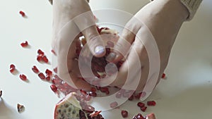A woman cleans a pomegranate