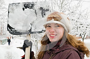 The woman cleans snow. photo