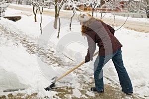 The woman cleans snow. photo