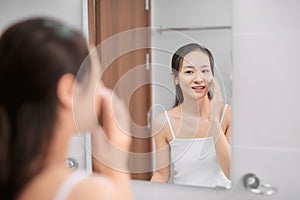 Woman clears a face skin foam on morning