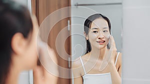 Woman clears a face skin foam on morning