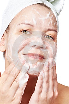 Woman clears a face skin foam