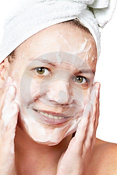 Woman clears a face skin foam