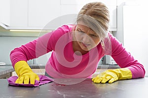 Woman clening a stain on kitchen counter
