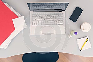 Woman clerk is sitting at office table holding note sticker with message call mum