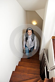 Woman climb interior stairs