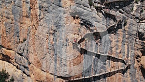 Woman climb to top of cliff on hot summer day