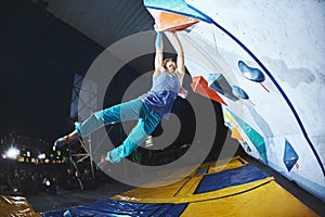 Woman climber on the climbing competition