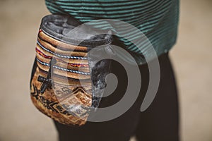 Woman climber with her climbing chalk bag.