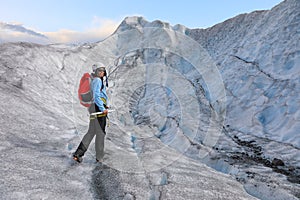 Woman climber standing in the cleft of the glacier