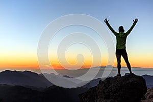 Woman climber success silhouette in mountains, achievement inspiration