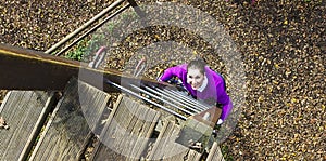 Woman climbing in adventure park