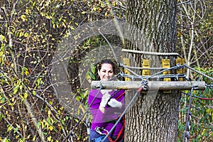 Woman climbing in adventure park