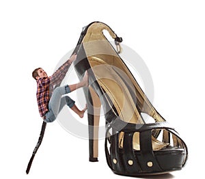 Woman climbing a huge shoe