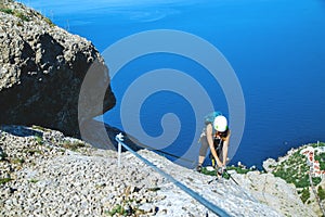 Woman climbing mountain