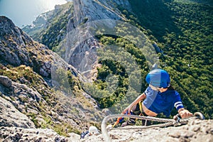 Woman climbing mountain