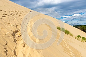 Woman climbing the Pyla dune
