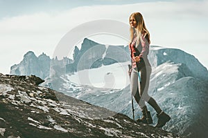 Woman climbing to mountain summit