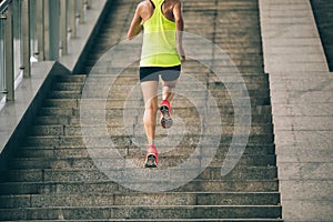 Woman climbing up city stairs jogging and running
