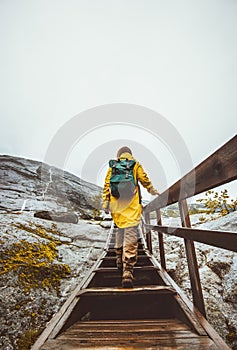 Woman climbing up stairs alone in mountains