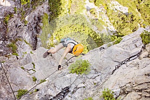 Woman climbing via ferrata