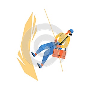 A woman climbs a rock with insurance, in a helmet with a briefcase. Business insurance and support concept