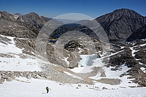 Woman Climbs Up Snowfield