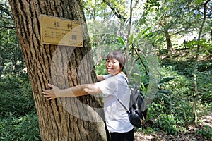 Woman clinging to the old camphor tree, adobe rgb