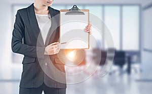 Woman with clipboard in office meeting room