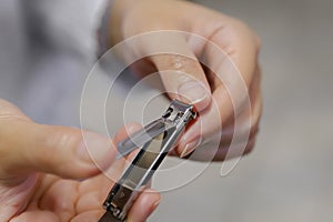 Woman Clipping Fingernail