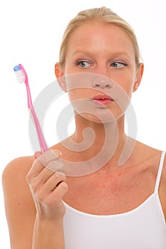 Woman with close mouth holding a toothbrush