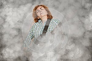 Woman with closed eyes playing electric guitar