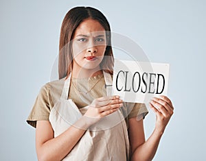 Woman, closed sign and entrepreneur in studio portrait for worry, angry or frustrated by background. Entrepreneurship