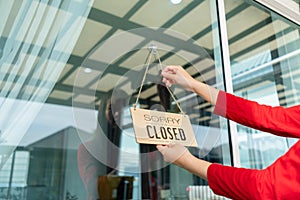 Woman closed store with sign board front door shop, Small business come back turning