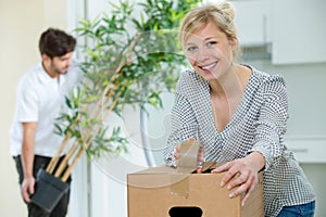 woman closing boxes to move to new house