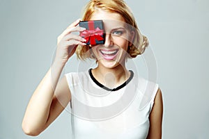 Woman closing eye with jewelery gift box