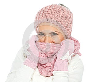 Woman closing face with knit scarf