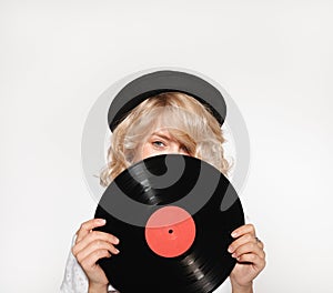 Woman closing face with vinyl record