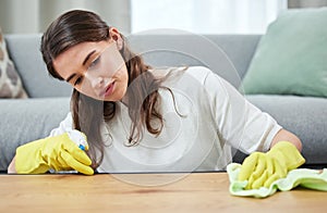 Woman, cloth and gloves for cleaning wood table for spray, chemical or hygiene in home living room. Girl, cleaner and