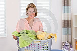 Woman With Clothes Basket And Electric Iron