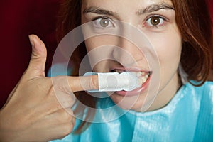 Woman clothing cleans teeth before professional teeth