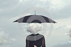 Woman with cloud head sheltering herself from the rain with umbrella