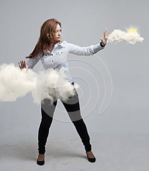 Woman with cloud and sun. Concept on the topic of computer cloud services.