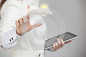Woman with cloud and sun. Concept on the topic of computer cloud services.