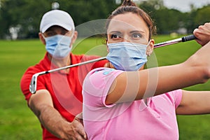 Woman with a club over her head staring away