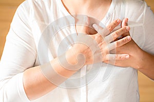 Woman is clutching her chest