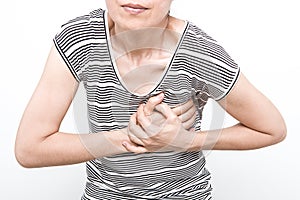 Woman is clutching her chest, acute pain possible heart attack.