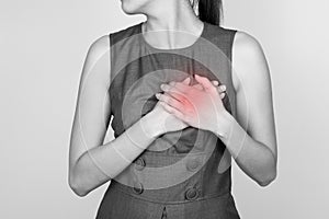 Woman is clutching her chest, acute pain possible heart attack