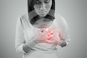 Woman is clutching her chest, acute pain possible heart attack